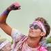 A runner pumps his fist during a dance party at Riverside Park after the Ypsilanti Color Run 5K on Sunday morning. Melanie Maxwell I AnnArbor.com